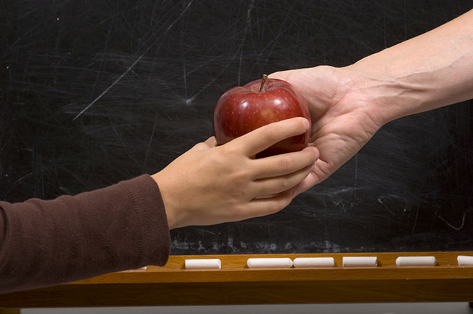 handing apple to child